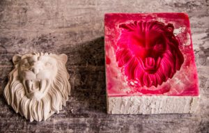 Lion silicone mould alongside plaster casting