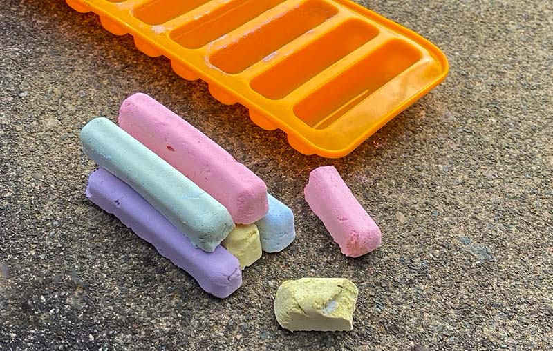 Homemade sidewalk chalk next to the silicone mould