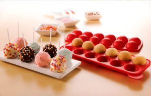 Chocolate Cake pops next to a cake pop silicone mold