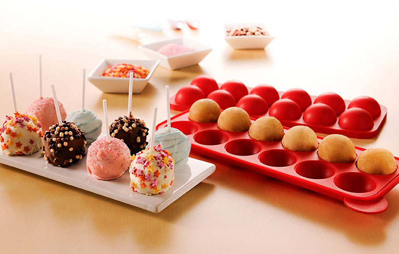 red silicone mould and some finished cake pops decorated with chocolate