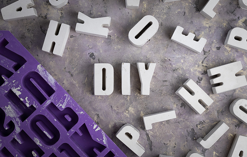 Cement letters make using a silicone mould - spelling 'DIY'