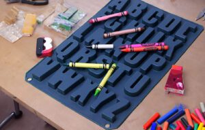 homemade personalised letter crayons next to a silicone mould