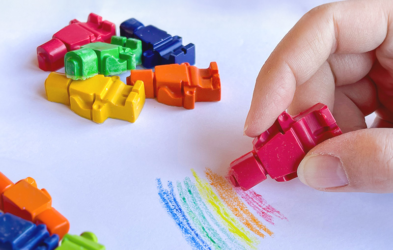 colouring using homemade lego mini figure shaped crayons. make your own crayons