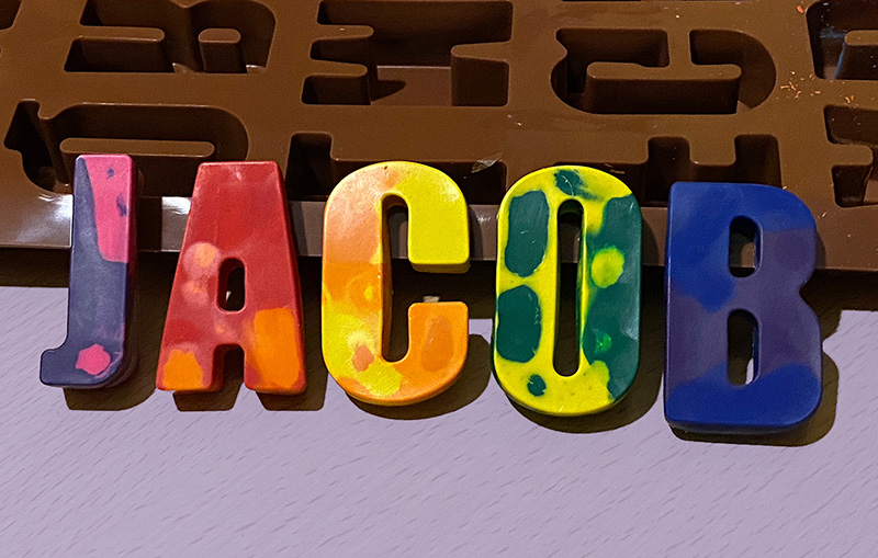 personalised letter crayons spelling JACOB. Make your own crayons