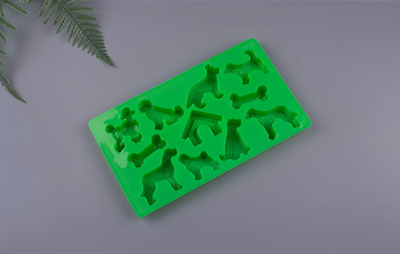 unique green silicone dog treat mold with a dog house cavity