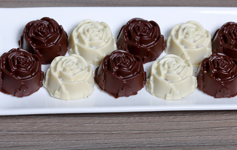 de-moulding from a silicone mould to reveal rose detailed chocolates