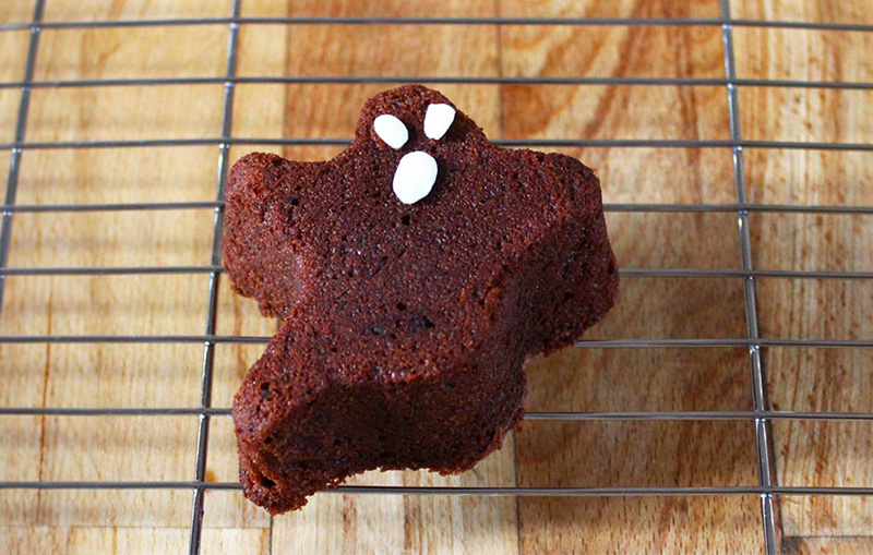 Chocolate ghost cake on a cooling rack