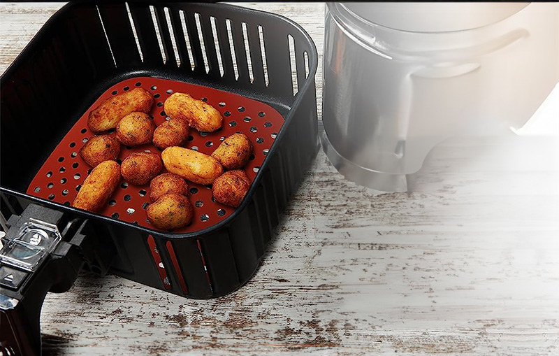 Square silicone air fryer liner in a air fryer basket