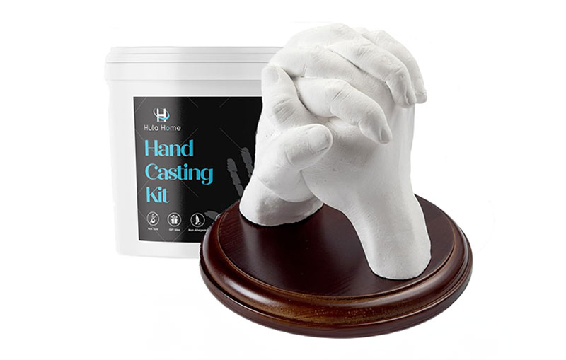 Hand casting kit with a sculpture of two hands holding