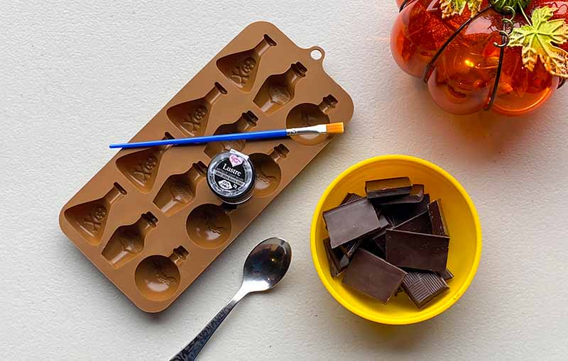 Bottle shapes silicone mould with ingredients including dark chocolate to make halloween chocolate candy