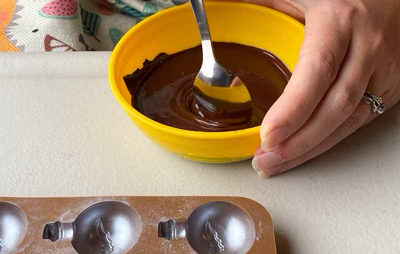 Melting dark chocolate in a bowl, ready to pour into a silicone mould