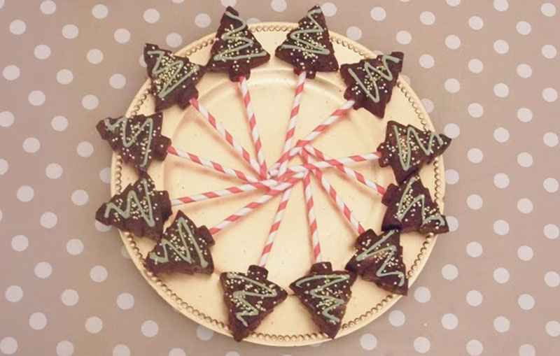 Christmas tree cake pops presented in a circle on a plate