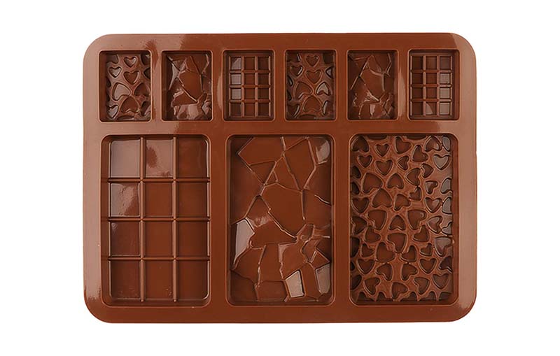 A versatile silicone chocolate mold in brown featuring 3 large cavities and 6 small cavities, with each containing a textured design