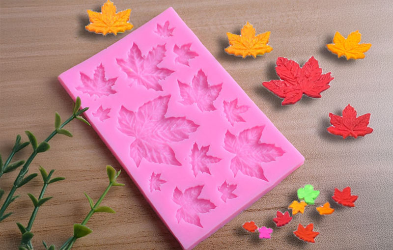 Clay for silicone molds - Pink silicone mold with leaf shapes and colorful clay leaves.