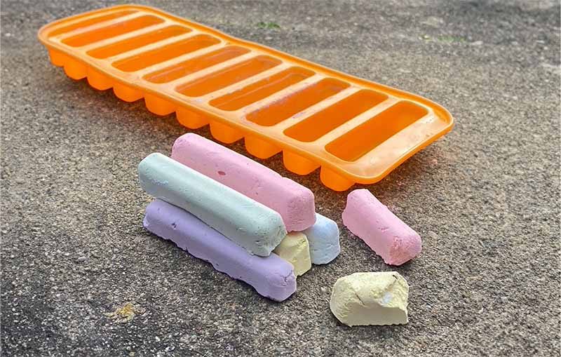 Crafting with kids to make chalks in different colours next to an orange craft silicone mould